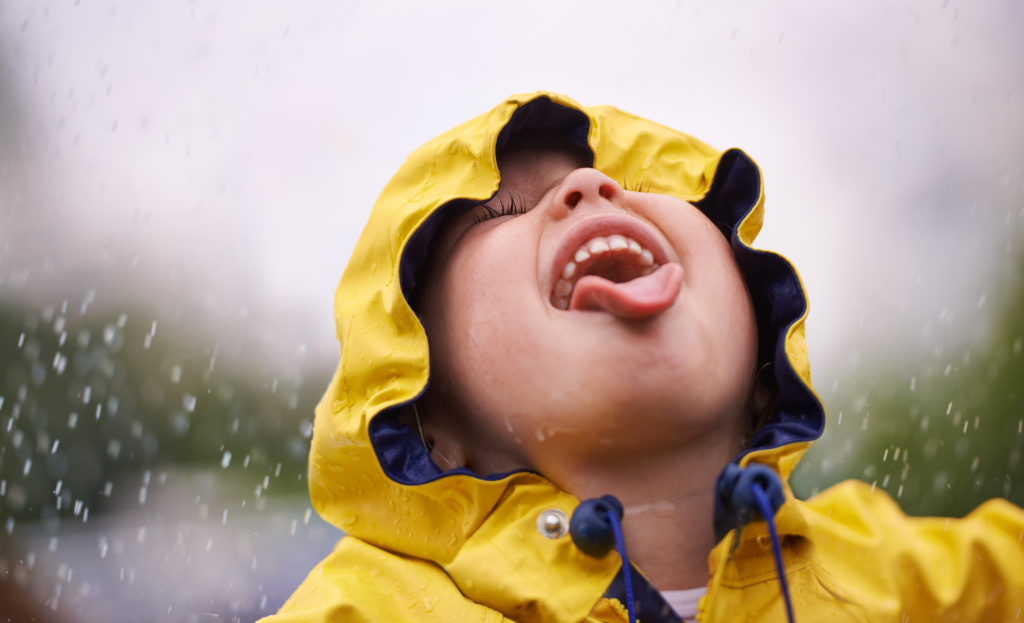 A child having fun in the rain