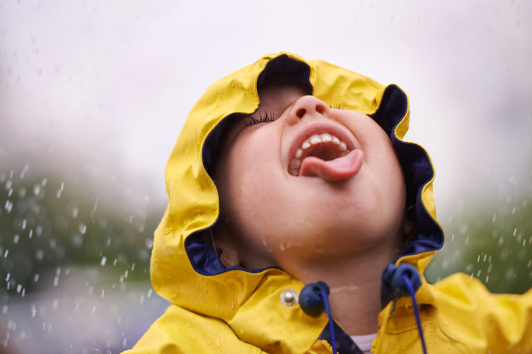 A child having fun in the rain