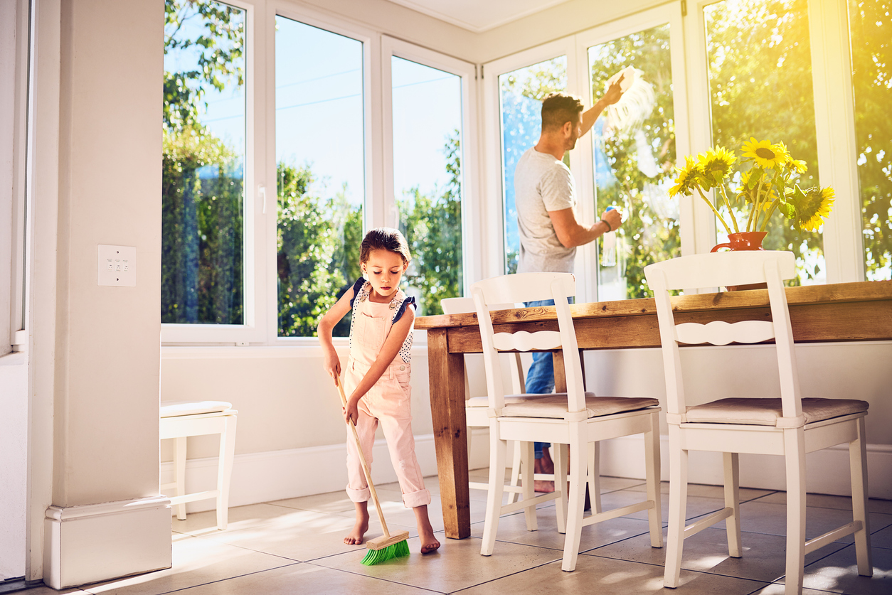 Shot of a father and his little daughter doing chores together at home